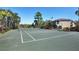 Well-maintained tennis court with surrounding landscaping at 5700 Bentgrass Dr # 16-211, Sarasota, FL 34235