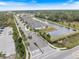 Aerial view of community with lake and neighborhood entrance at 6077 Amberly Dr, Bradenton, FL 34208