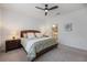 Spacious bedroom with ceiling fan, wood furniture and ensuite bathroom at 6077 Amberly Dr, Bradenton, FL 34208