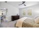 Bright bedroom with a dresser, ceiling fan and access to the back patio at 6077 Amberly Dr, Bradenton, FL 34208