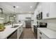 Modern kitchen with white cabinets, stainless steel appliances, and a large island at 6077 Amberly Dr, Bradenton, FL 34208