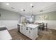 Open floor plan showing kitchen with island, dining area and Gathering room at 6077 Amberly Dr, Bradenton, FL 34208