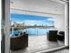 Spacious balcony with water views and wicker furniture at 650 Golden Gate Pt # 401, Sarasota, FL 34236