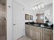 Bathroom with granite countertop, light cabinets and walk-in shower at 650 Golden Gate Pt # 401, Sarasota, FL 34236