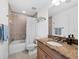 Bathroom with granite countertop, tub and shower at 650 Golden Gate Pt # 401, Sarasota, FL 34236