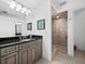 Bathroom with granite vanity and walk-in shower at 650 Golden Gate Pt # 401, Sarasota, FL 34236