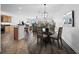 Open concept dining room with glass table and chairs, kitchen views at 650 Golden Gate Pt # 401, Sarasota, FL 34236
