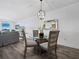 Bright dining area with glass-top table and four chairs at 650 Golden Gate Pt # 401, Sarasota, FL 34236