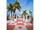 Entrance to a community with palm trees at 650 Golden Gate Pt # 401, Sarasota, FL 34236