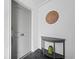 Bright entryway with gray door, half-moon table, and decorative wall art at 650 Golden Gate Pt # 401, Sarasota, FL 34236