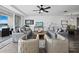 Spacious living room with water views, comfy seating, and hardwood floors at 650 Golden Gate Pt # 401, Sarasota, FL 34236
