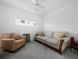 Living room with sofa, armchair and window with city view at 650 Golden Gate Pt # 401, Sarasota, FL 34236