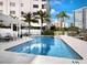 Community pool with lounge chairs and waterfront view at 650 Golden Gate Pt # 401, Sarasota, FL 34236