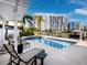 Community pool with lounge chairs and waterfront view at 650 Golden Gate Pt # 401, Sarasota, FL 34236