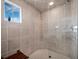 Large walk-in shower with tiled walls and built-in seat at 650 Golden Gate Pt # 401, Sarasota, FL 34236