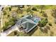 Single-Gathering home with pool and landscaped yard; aerial view at 6702 Pinehurst Pl, Bradenton, FL 34202