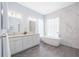 Modern bathroom with soaking tub and double vanity at 6702 Pinehurst Pl, Bradenton, FL 34202