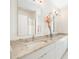 Elegant bathroom with double vanity, marble countertop, and large mirror at 6702 Pinehurst Pl, Bradenton, FL 34202