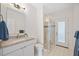 Clean bathroom with single vanity, shower, and exterior access at 6702 Pinehurst Pl, Bradenton, FL 34202