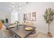 Elegant dining room with a dark wood table and modern chandelier at 6702 Pinehurst Pl, Bradenton, FL 34202