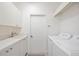 Bright laundry room, washer, dryer, and ample cabinets at 6702 Pinehurst Pl, Bradenton, FL 34202