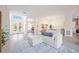 Open concept living room with a comfortable sofa and access to the pool area at 6702 Pinehurst Pl, Bradenton, FL 34202