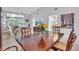 Bright dining room with wood table and seating, offering a view into the living area at 6807 Stone River Rd # 204, Bradenton, FL 34203
