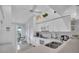 Bright white kitchen with view to living area at 6807 Stone River Rd # 204, Bradenton, FL 34203
