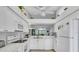 White kitchen with appliances and breakfast bar at 6807 Stone River Rd # 204, Bradenton, FL 34203