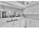 White kitchen with double sink and breakfast bar at 6807 Stone River Rd # 204, Bradenton, FL 34203