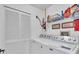 Bright laundry room with washer, dryer, and shelving at 6807 Stone River Rd # 204, Bradenton, FL 34203
