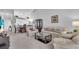 Relaxing living room with light beige couches and large TV at 6807 Stone River Rd # 204, Bradenton, FL 34203