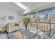 Sunroom with comfy seating and large windows overlooking a tranquil landscape at 6807 Stone River Rd # 204, Bradenton, FL 34203
