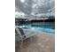 Large community pool with plenty of lounge chairs at 6807 Stone River Rd # 204, Bradenton, FL 34203