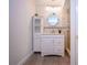 Updated bathroom with white vanity, tile shower, and a stylish mirror at 7213 Las Casas Dr, Sarasota, FL 34243
