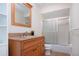 Bathroom with wood vanity, granite countertop, and tub shower combo at 7213 Las Casas Dr, Sarasota, FL 34243