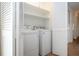 Convenient laundry room with washer, dryer, and built-in shelving at 7213 Las Casas Dr, Sarasota, FL 34243