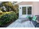 Small patio with seating area, next to lush landscaping at 7213 Las Casas Dr, Sarasota, FL 34243