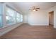 Bright sunroom with large windows and wood-look floors at 7213 Las Casas Dr, Sarasota, FL 34243