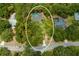 Bird's-eye view of house, pool, and surrounding trees at 7408 Oak Run Ln, Sarasota, FL 34243