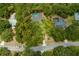 Aerial perspective of homes nestled in a tree-lined neighborhood at 7408 Oak Run Ln, Sarasota, FL 34243
