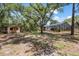 Spacious backyard showcasing a pool, cabana, and mature trees at 7408 Oak Run Ln, Sarasota, FL 34243