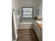 Bathroom with soaking tub and double vanity at 7408 Oak Run Ln, Sarasota, FL 34243