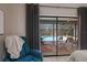 Bedroom with sliding glass doors offering a pool view at 7408 Oak Run Ln, Sarasota, FL 34243