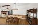 Dining area with a farmhouse table and chairs, adjacent to the living room at 7408 Oak Run Ln, Sarasota, FL 34243