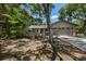 Tan house with gray garage doors and mature landscaping at 7408 Oak Run Ln, Sarasota, FL 34243