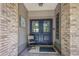 Inviting front entrance with double doors, brick accents, and a welcoming mat at 7408 Oak Run Ln, Sarasota, FL 34243