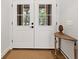 Bright and airy front entry with white double doors and a half-moon table at 7408 Oak Run Ln, Sarasota, FL 34243