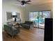 Gathering room with wood-look floors, sliding glass doors to the pool, and comfy seating at 7408 Oak Run Ln, Sarasota, FL 34243