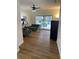 Gathering room with wood-look floors, sliding glass doors to the pool, and comfy seating at 7408 Oak Run Ln, Sarasota, FL 34243
